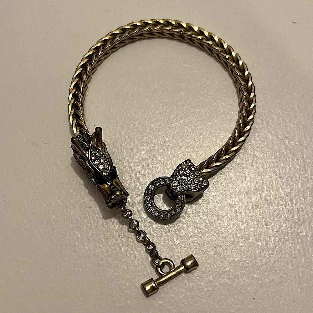 Vintage/used gold-toned bracelet with a dragon CZ studded clasp.
